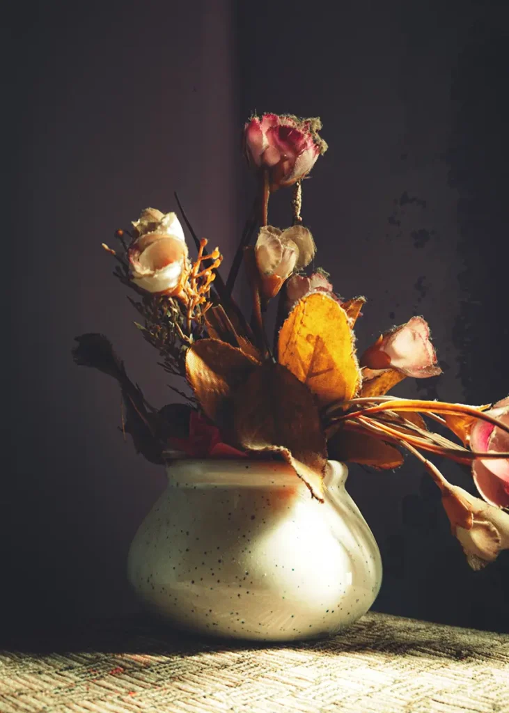 Side light falls across the flowers and vase