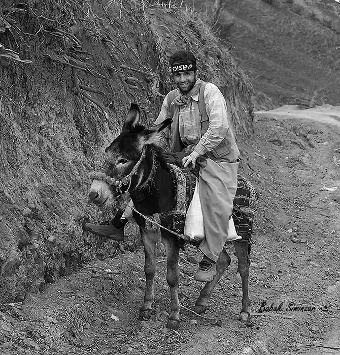 A man rides a donkey